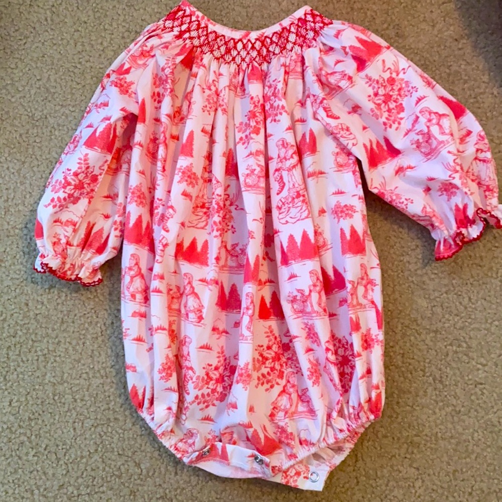 This is a Magnolia Steel Christmas Romper. It is pink and Red. Size 12 months